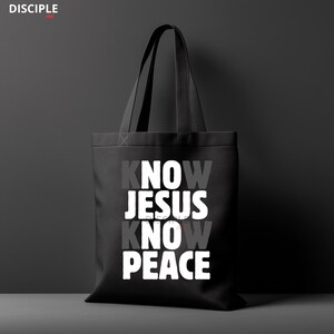 May include: Black tote bag with the text "KNOW JESUS KNOW PEACE" in white and gray lettering. The bag has two black handles and the word "DISCIPLE" in the upper left corner.