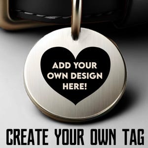 May include: A circular, brushed metal pet tag featuring a black heart design. The heart has the text "ADD YOUR OWN DESIGN HERE!". The tag is attached to a metal loop. The words "CREATE YOUR OWN TAG" are at the bottom.