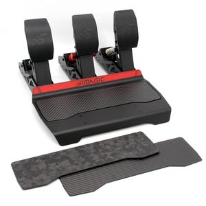 May include: A black racing pedal set with three pedals, a carbon fibre textured footrest, and a red accent bar featuring the SIMAGIC logo. Two additional rectangular adhesive plates with carbon fibre and forged carbon patterns are included.