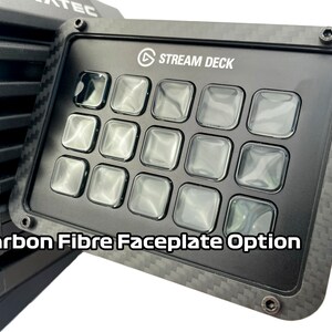 May include: Black Stream Deck with a carbon fiber faceplate option. The device has 15 clear, square buttons and the text "STREAM DECK" is visible. The faceplate is framed with a carbon fiber texture, and the text "Carbon Fibre Faceplate Option" is displayed.