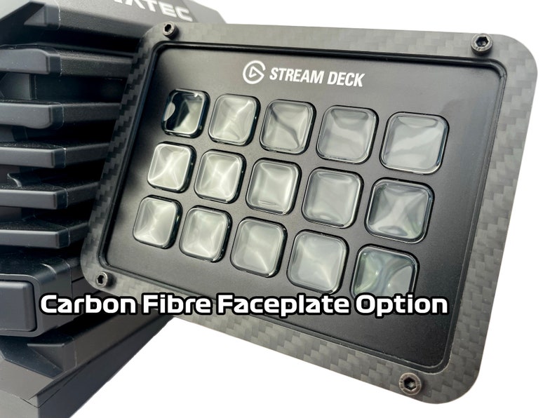 May include: Black Stream Deck with a carbon fiber faceplate option. The device has 15 clear, square buttons and the text "STREAM DECK" is visible. The faceplate is framed with a carbon fiber texture, and the text "Carbon Fibre Faceplate Option" is displayed.