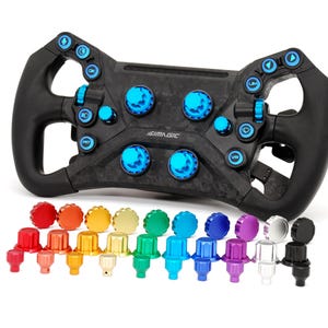 May include: A black racing wheel with blue and black buttons and knobs. The wheel has a carbon fibre texture and the brand name "AIMAGIC" is visible. A variety of colourful knobs are arranged below the wheel.
