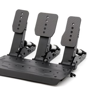 May include: A black racing simulator pedal set with three pedals. The pedals have a carbon fiber texture and are mounted on a black base. The set is designed for sim racing enthusiasts.