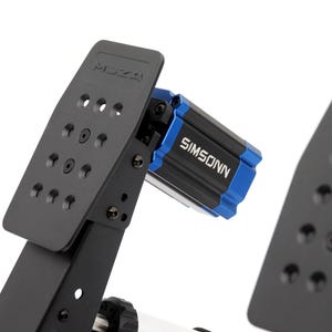 May include: A black metal racing pedal set featuring a vertical pedal face with multiple circular cutouts and the MOZA logo embossed at the top. A blue and black rectangular component labeled SIMSONN is attached to the side of the pedal arm.