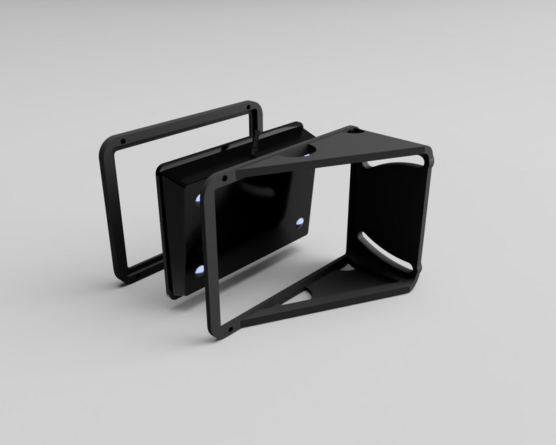May include: A black, geometric, three-dimensional object with a rectangular frame and a triangular base. The object has a modern, minimalist design, with a handle on top. The object appears to be made of metal or a similar material.
