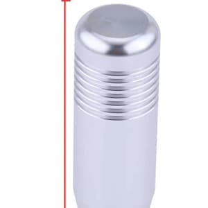 May include: Silver gear shift knob with a ribbed design. It measures 1.10 inches in diameter and 3.35 inches in height.