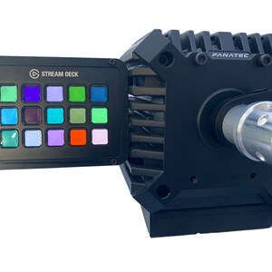 May include: A black Stream Deck with multi-colored buttons is attached to a black Fanatec device. The Stream Deck has the logo and text "STREAM DECK" on it. The Fanatec device has the text "FANATEC" on it.