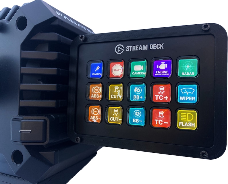 May include: Black Stream Deck control panel with illuminated buttons. The panel features buttons labeled "IGNITION", "START", "CAMERA", "ENGINE MANAGEMENT", "RADAR", "ABS+", "CUT+", "BB+", "TC+", "WIPER", "ABS-", "CUT-", "BB-", "TC-", and "FLASH".