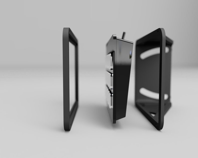 May include: A black, modular electronic device with a frame, a central unit with multiple compartments, and a back panel. The components are separated, suggesting assembly or customization. The design is modern and minimalist.