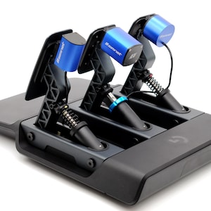 May include: A black and grey racing simulator pedal set with three pedals. The pedals have black bases, springs, and blue accents. The blue accents have the text "Simnet" printed on them. The base has the "G" logo.
