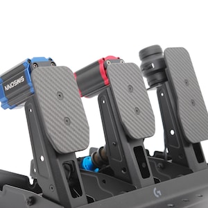May include: A close-up of a racing simulator pedal set. The set features three pedals with carbon fiber textured footplates. The components are black, blue, and red, with the brand name "SIMOSWISS" visible on one component.