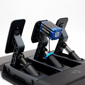 May include: A black and gray racing simulator pedal set. The set includes three pedals with springs and a blue and black SIMSONN component. The base is black with the Logitech logo.