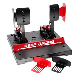 May include: A black and red racing pedal set with the text "KEEP RACING" on a red bar. The set includes two pedals, a base, and two additional pedal covers, one red and one black.