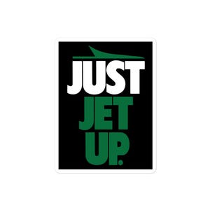 May include: Black and green sticker with the text "Just Jet Up" in white letters. The text "Jet" is in green and the text "Up" is in green with a period after it.