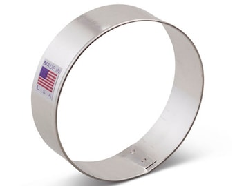 May include: A silver metal cookie cutter shaped like a circle. The cookie cutter has a label that says "Made in USA" with a small American flag.