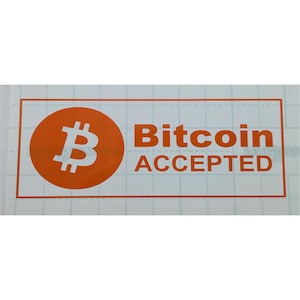 May include: A rectangular sticker with an orange border and the words "Bitcoin ACCEPTED" in orange. The Bitcoin symbol is in a circular orange shape on the left side of the sticker.