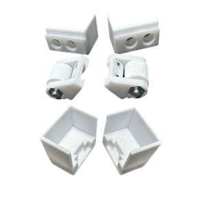 May include: Set of six white plastic corner brackets and two white plastic roller hinges. The brackets have two holes each and the hinges have a small metal roller.