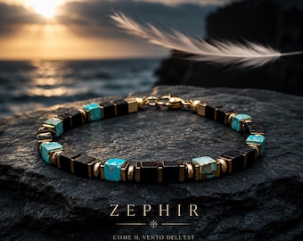 May include: A bracelet featuring alternating square black beads and turquoise stone beads with gold-tone metal spacers and a lobster claw clasp. The text ZEPHIR is printed below the bracelet, followed by the Italian phrase COME IL VENTO DELL'EST.