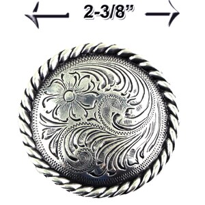May include: Silver belt buckle with a rope design border and a floral engraved design. The buckle measures 2-3/8 inches in diameter.