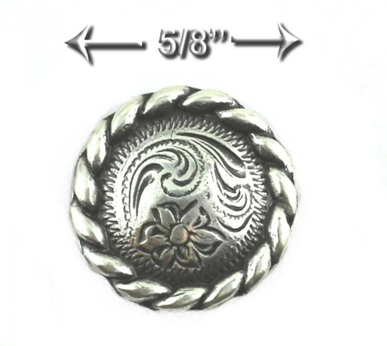 May include: Silver-toned metal button with a rope-like border and an engraved floral design. The button measures 5/8 inches in diameter.
