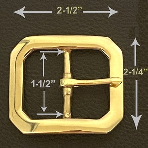 May include: A gold-tone metal buckle with a rectangular shape and a single prong. The buckle measures 2-1/2 inches wide and 2-1/4 inches tall.