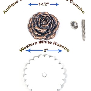May include: An antique copper Western Rose Concho, measuring 1-1/2 inches, and a Western White Rosette, measuring 2 inches, are displayed. The concho is a detailed rose design. The rosette is white with a scalloped edge. Includes a screw and a fastener.
