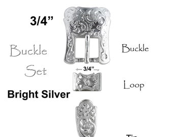 May include: A silver-toned Western-style buckle set with a floral engraved design. The buckle is 3/4 inches wide and includes a loop and tip.