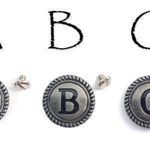 May include: Three silver-toned metal buttons with black letters A, B, and C. Each button has a rope-like border and comes with a small silver screw.