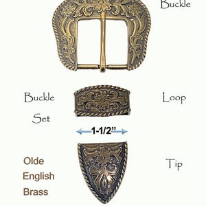 May include: A set of Western-style belt buckle and tip, featuring an engraved floral design. The buckle is 1-1/2 inches wide and made of Olde English Brass.