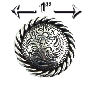 May include: Silver-toned metal button with a rope-like border and a floral design. The button is 1 inch in diameter.