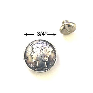 May include: A silver-colored screw head next to a 1944 Mercury dime. The screw head is approximately 3/4 inch in diameter. The dime features a profile of a person and the words "IN GOD WE TRUST".