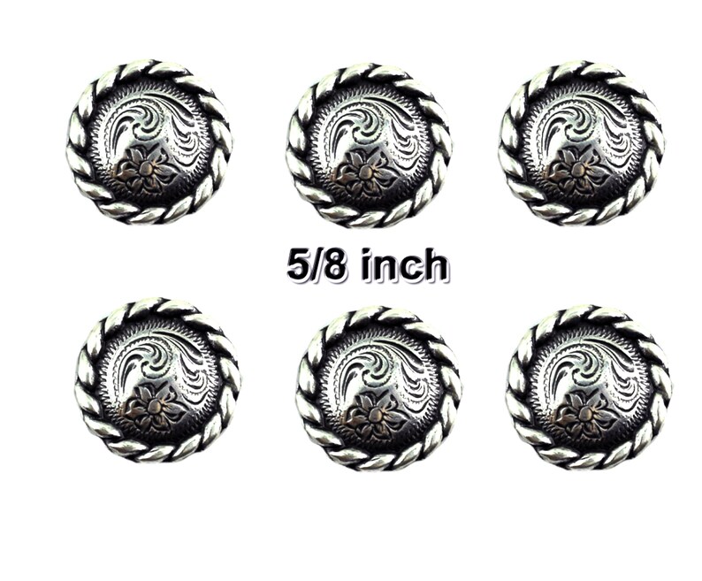 May include: Six silver-toned metal buttons with a rope-like border and a floral design. The buttons are 5/8 inch in diameter.