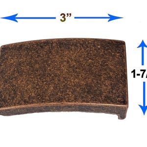 May include: A white ceramic mug with a black handle and the text "But First, Coffee" in a bold, black font. The mug is filled with a dark liquid, likely coffee, and sits on a light-colored surface.