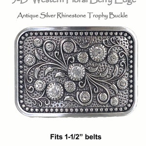 May include: Silver belt buckle with a 3-D floral design and clear rhinestones. The buckle is engraved with a berry edge and says "3-D Western Floral Berry Edge" and "Antique Silver Rhinestone Trophy Buckle". It fits 1-1/2 inch belts.