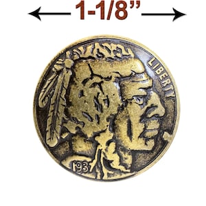 May include: A gold-toned metal coin with a profile of a Native American man on one side and the word "LIBERTY" on the other. The coin is 1-1/8 inches in diameter and has the year "1937" inscribed on it.