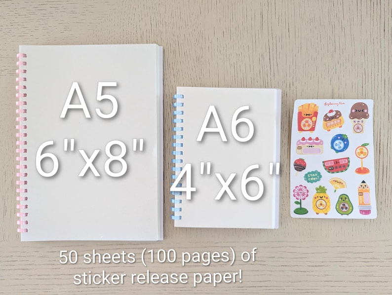 May include: Two white spiral-bound notebooks, A5 size (15.24cm x 20.32cm) and A6 size (10.16cm x 15.24cm), and a sheet of colorful stickers. The notebooks have pink and blue spirals. The text reads "50 sheets (100 pages) of sticker release paper!"