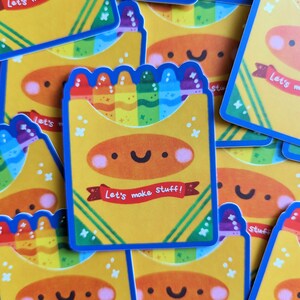 May include: A stack of colorful stickers with a rainbow of crayons and the text "Let's make stuff!" on a yellow background.