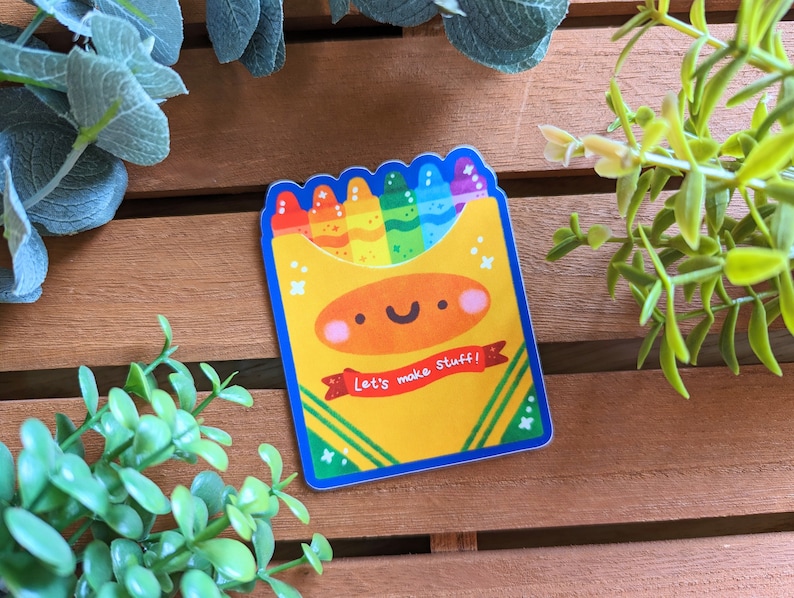 May include: A colorful sticker of a box of crayons with a smiling face and the text "Let's make stuff!" The crayons are arranged in a rainbow pattern.