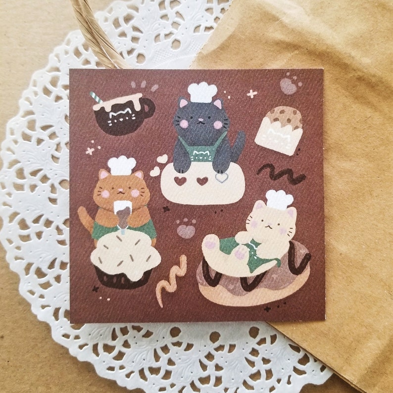 A print of cats baking and decorating for a cafe.