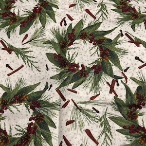 May include: A fabric with a repeating pattern of Christmas wreaths, pine needles, red berries, and cinnamon sticks on a speckled white background. The wreaths are composed of green leaves and pinecones.