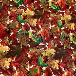 May include: A fabric pattern featuring a dense arrangement of autumn leaves in various colors. The leaves display shades of red, orange, green, and yellow, creating a vibrant and seasonal design. The leaves are layered and overlapping.