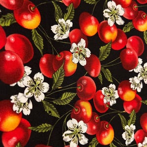 May include: A black fabric with a repeating pattern of red cherries and white flowers. The cherries are depicted with a yellow highlight on the bottom half of each cherry.