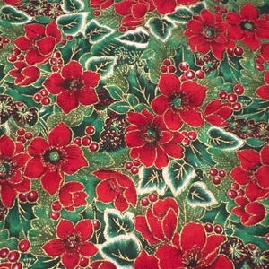 May include: Red and green Christmas fabric with a floral pattern. The fabric features red flowers with gold accents and green leaves.