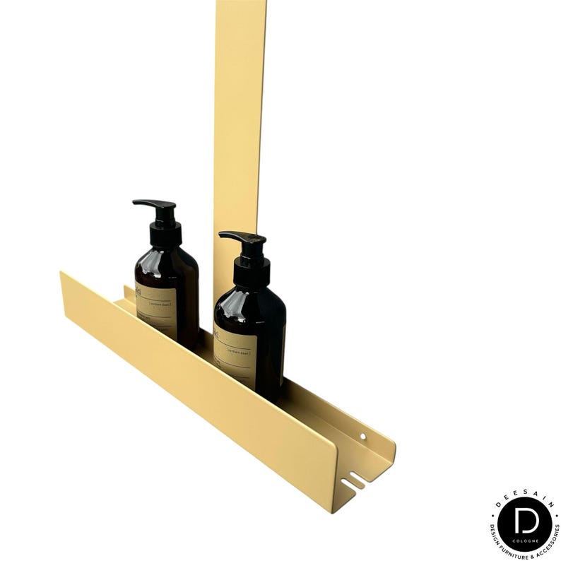 May include: A matte light yellow metal wall-mounted shelf with a vertical back panel and a horizontal tray holding two dark brown plastic pump bottles with black dispensers. The shelf features a small circular hole and a rectangular slot on the side.