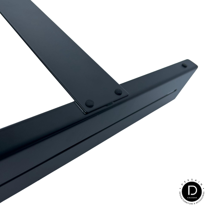 May include: A matte black metal furniture leg featuring a flat, rectangular mounting plate attached to a sturdy, angled support beam. The structure includes small, circular rubber pads at the connection point and the end of the leg for stability.