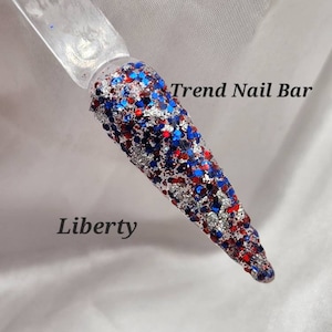 May include: A close-up of a red, white, and blue glitter nail polish with the text "Trend Nail Bar" and "Liberty" on a white background.