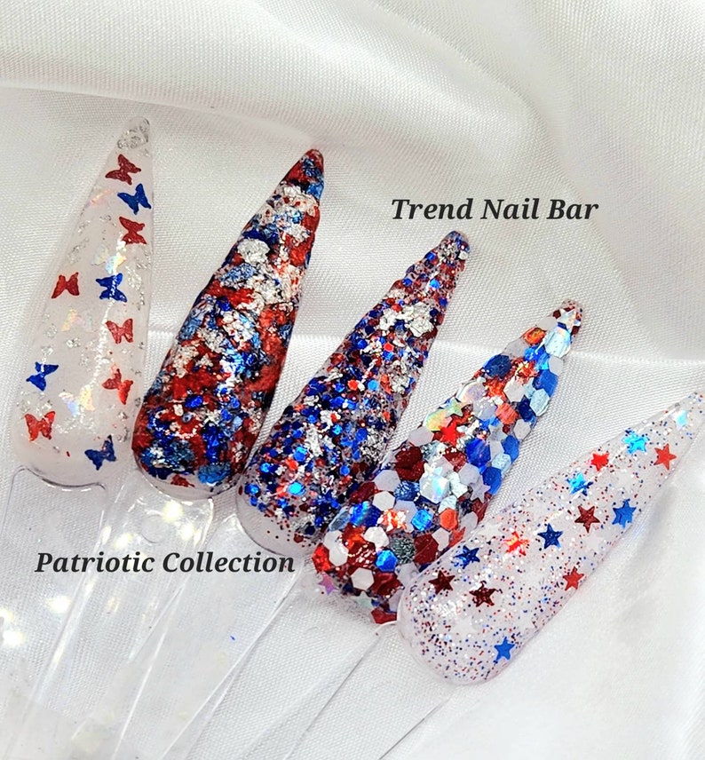 May include: Four nail polish bottles with red, white, and blue glitter. The bottles are labeled "Trend Nail Bar" and "Patriotic Collection".