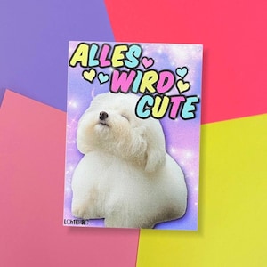 Könnte beinhalten: Ein rechteckiger Aufkleber mit dem Text "ALLES WIRD CUTE" in bunten Buchstaben mit Herzen. Der Aufkleber zeigt einen flauschigen weißen Hund mit geschlossenen Augen vor einem lila Hintergrund. Der Aufkleber befindet sich auf einem farbenfrohen Hintergrund.
