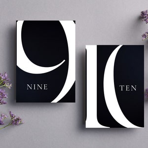 May include: Two black cards with white numbers and text. The first card has the number nine and the word "NINE" below it. The second card has the number ten and the word "TEN" below it.