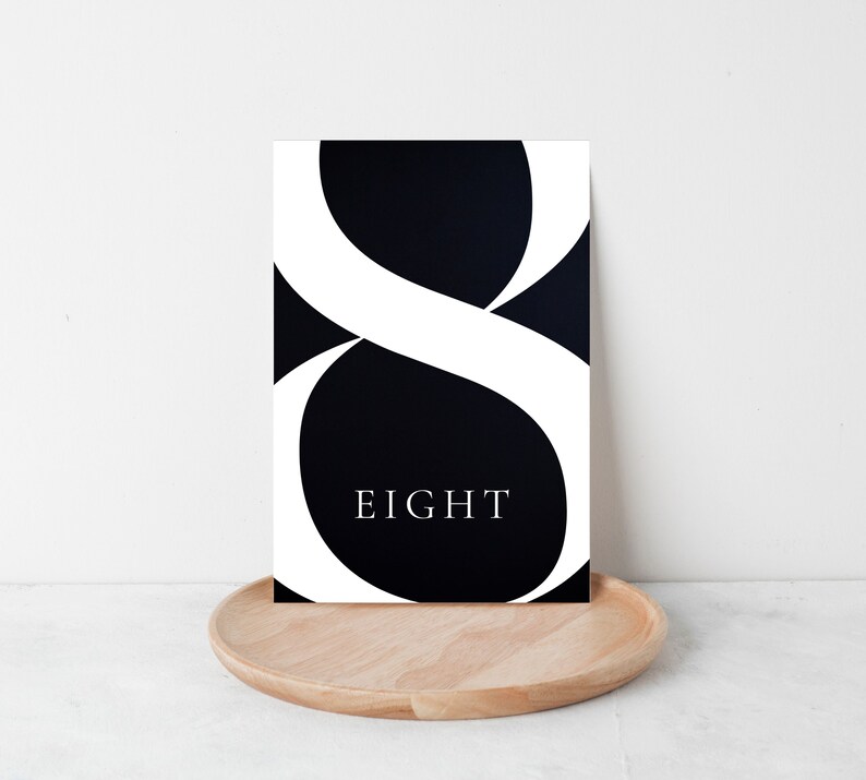 May include: Black and white printable art print with a large white number eight and the word "EIGHT" in white text on a black background.